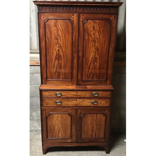 A Regency mahogany tall cabinet on chest, two door base with...