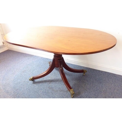 A Regency period oval mahogany tilt-top breakfast table on t...