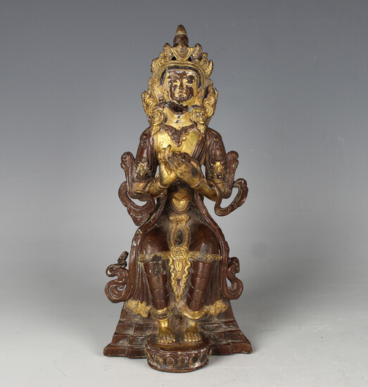 A Tibetan brown patinated and parcel gilt bronze figure of a bodhisattva, probably 17th, modelled se