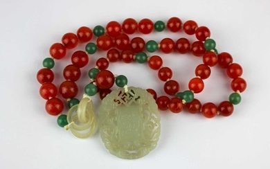 A carved jade oval pendant