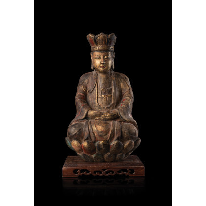 A carved wood seated Buddha, on stand (defects) China, Ming dynasty, 17th century (h. 38 cm.)