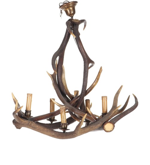 A ceiling lamp of antlers from stag, with six patinated brass socket houses. Early 20th century. H. 74. Diam. 75 cm.