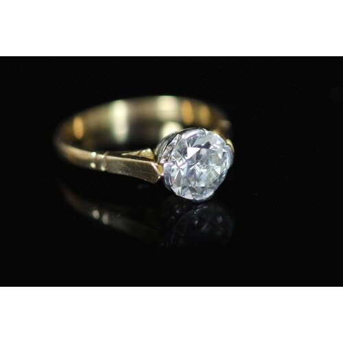 A gold and solitaire diamond ring, the round cut stone weigh...