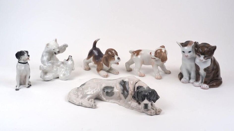 A group of ceramic animals, 20th century, to include two Royal Copenhagen puppies, no. 444 & 564, each approximately 11cm high, a Royal Copenhagen group of two polar bears playing, no. 1107, a Rosenthal figure group of two cats, a Rosenthal...
