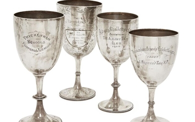 A group of four silver trophy cups, various marks including London, c.1890, and Birmingham, c.1905, and makers including Charles Stuart Harris and Atkin Brothers, all designed with knopped stems and beaded circular feet, presentation engraving to...
