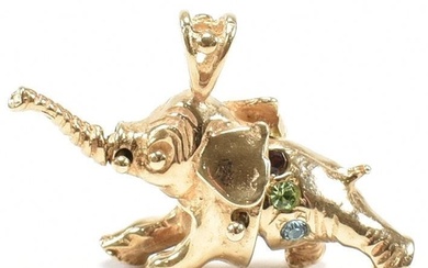 A hallmarked 9ct gold and gem set elephant pendant. The elep...