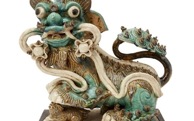 A large Chinese pottery figure of a Buddhist lion, late Ming dynasty, modelled seated, with back glazed in tones of turquoise and yellow, 36cm high