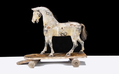 A late 19th century English carved and painted wooden horse on wheels
