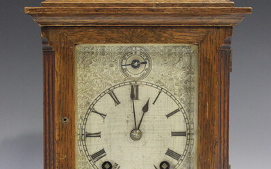 A late Victorian oak cased mantel clock with eight day movement striking on two gongs, the backplate