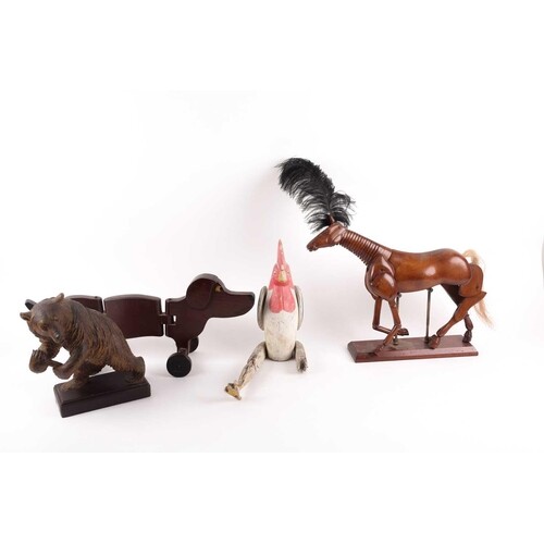 A menagerie of carved wooden and articulated animals, to inc...