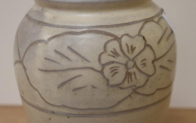 A mid-20th Century studio pottery vase, decorated with a band of flowers against a beige ground