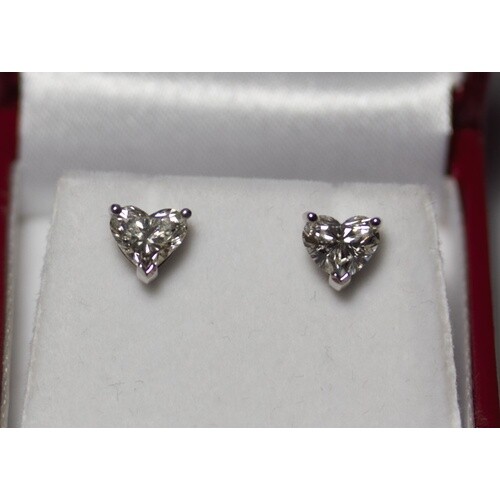 A pair of 18ct white gold heart shaped diamond solitaire stu...