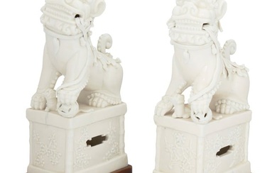 A pair of Chinese Dehua-style porcelain guardian lions