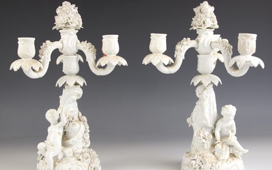 A pair of German porcelain white glazed figural candelabra, ...