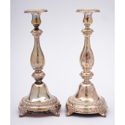 A pair of German silver candlesticks, stamped 880: with urn ...