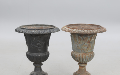 A pair of cast iron garden urns.