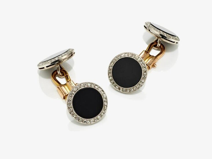 A pair of cufflinks with onyx and diamond roses