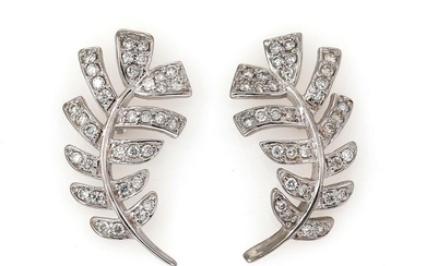 A pair of diamond ear studs in the shape of a leaf...