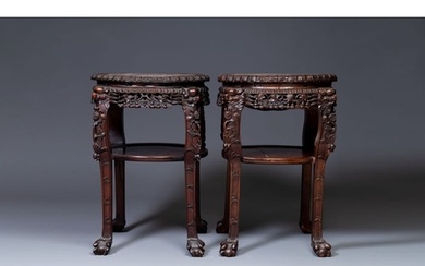 A pair of large Chinese carved wooden stands with marble top...