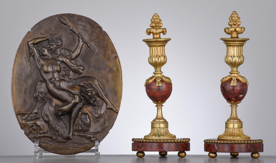 A patinated bronze plaque by Clodion, and a pair of Napoleon III candleholders, H 25 - 26 cm