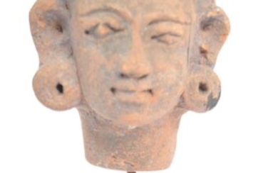 A pre Columbian head of stand. A terracotta / pottery carved head, with naïve facial features and elongated ear lobs. Mounted on a later stand. Approximately 9cm.