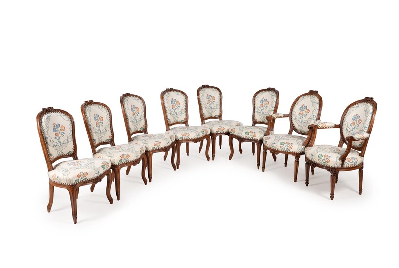 A set of eight Louis XV/Louis XVI transitional walnut and upholstered dining chairs