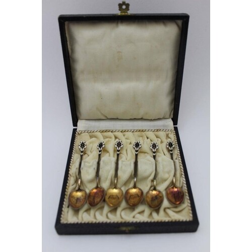 A set of six silver gilt coffee spoons with enamelled handle...