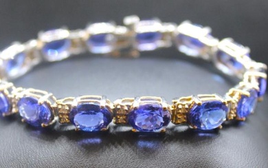 A tanzanite and diamond set 14ct white gold line bracelet,...