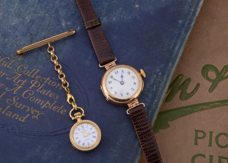A vintage 9ct gold cased lady's wristwatch and a gold plated nurse's watch on a 9ct gold support