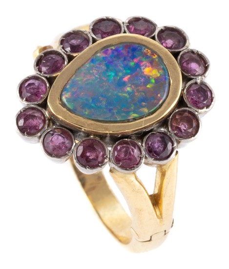 AN 18CT TWO TONE GOLD OPAL AND RUBY CLUSTER RING; centre collet set in yellow gold with a pear shape opal doublet plaque (10.2 x 7.1...