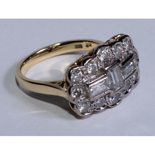 An 18ct gold and diamond ring, the central three baguette cu...