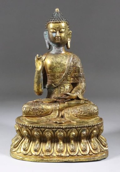 An Indo Chinese Gilt Bronze Figure of a Seated...