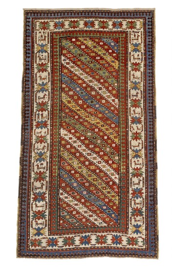 An antique Gendje rug, Caucasus. Design with diagonal stripes in different colours surrounded by crab main border. 19th century. 228×126 cm.