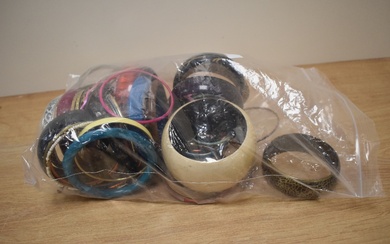 An assortment of costume bracelets including wooden bangles, statement bangles and paste set bangles