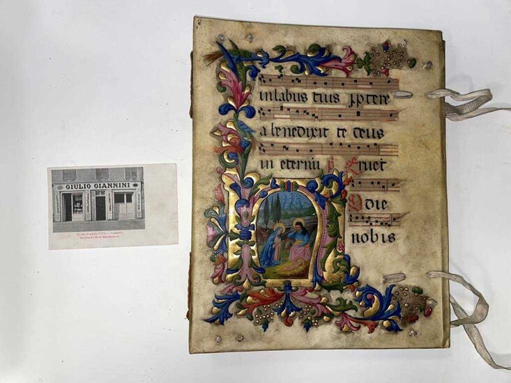 An illuminated vellum covered album, early 20th century, 33 x 27cm, the front board painted with a