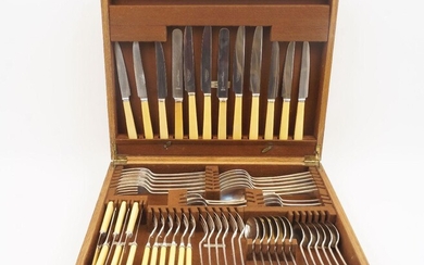 An oak canteen of Elkington Plate cutlery, comprising: six table forks, six table spoons; six teaspoons; six dessert spoons; six soup spoons; and five dessert forks with monogram N; six cream handled fish knives and six fish forks; six cream...