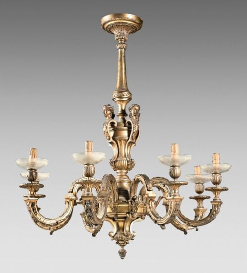 Gilt bronze chandelier with eight sinuous leafy light arms. Baluster shaft with flutes, gadroons and four female caryatids and ibex heads. Crystal bobèches.