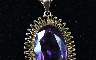 Lot details A contemporary amethyst and yellow metal pendant, the...