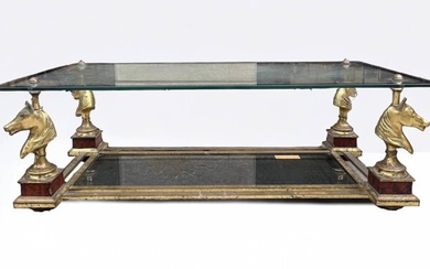 MAISON CHARLES Table basse en laiton à plateau de verre soutenu par quatre pieds en...