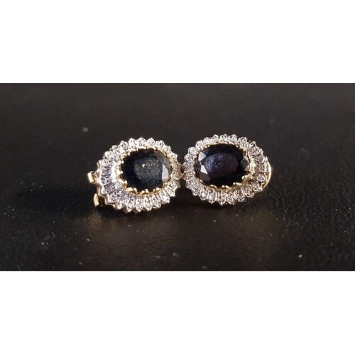 PAIR OF SAPPHIRE AND DIAMOND CLUSTER EARRINGS the central ov...