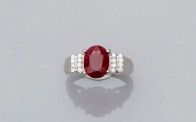 Ring in white gold, 750 MM, set with an oval ruby weighing about 3 carats, stepped with diamond steps, size: 55, weight: 4.7gr. rough.