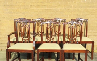 Seven 20th century mahogany dining chairs to include a carve...