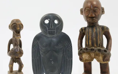 Two African carved hardwood figures, 20th century, depicting a prisoner standing with...
