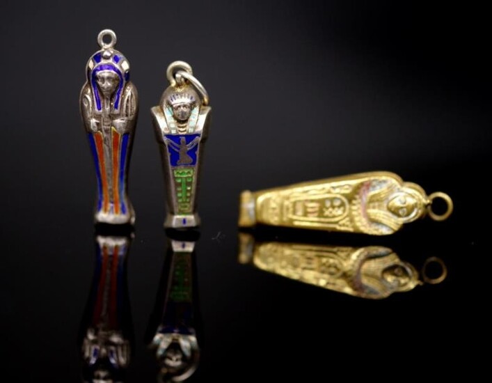 Two silver 1920's silver sarcophagus form pendants and a...