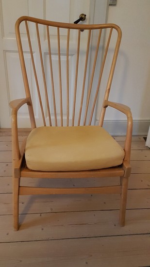 Unknown designer: An easy chair of birch. Cushion upholstered with yellow fabric. Probably designed and manufactured in Sweden. H. 100 cm. W. 68 cm.