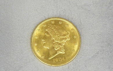 A gold 20-dollar coin dated 1904 Liberty's head.