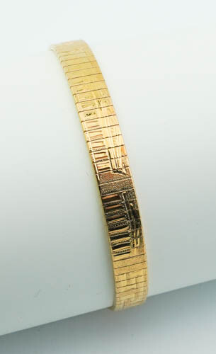 18K (750) YELLOW GOLD FLEXIBLE STRAP BRACELET. Textured strap lightly...