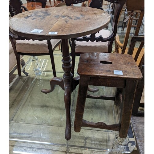 A 19th century oak stool and an oak tripod table, table diam...