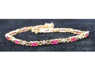 A 9ct gold ladies bracelet set with small rubies and diamond...