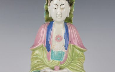A Chinese famille rose enamelled porcelain figure of Guanyin, Qianlong period, modelled seated on a